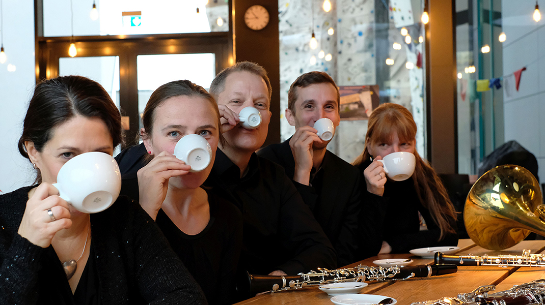 Fünf Musiker trinken Kaffee