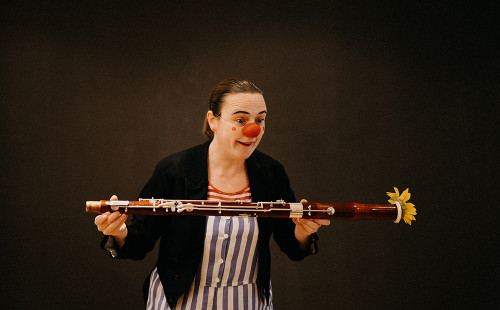 Clown hält Instrumententeil in der Hand
